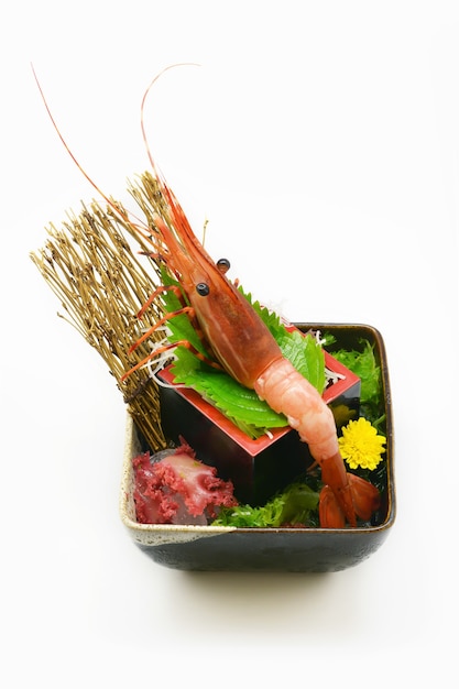 Botan Ebi Sashimi in black bowl Japanese styleon white background