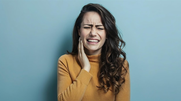 Photo bothered cute woman grimacing from pain and touching cheek complaining on toothache need dentist