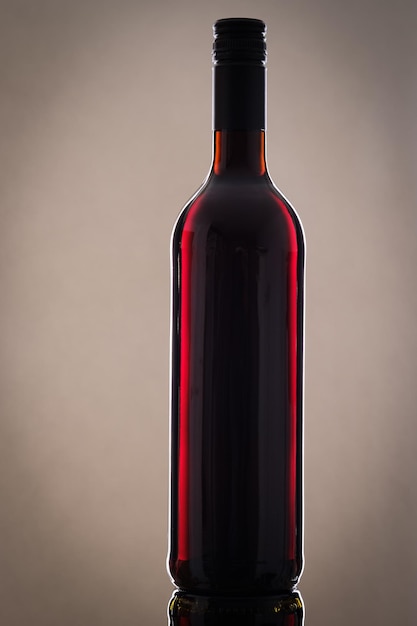 Botte red wine with grey background and light reflection