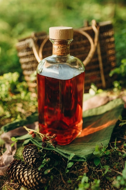 a bottle of alcohol on a forest background