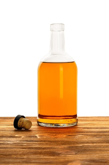 Bottle of alcohol with a cork on a white background