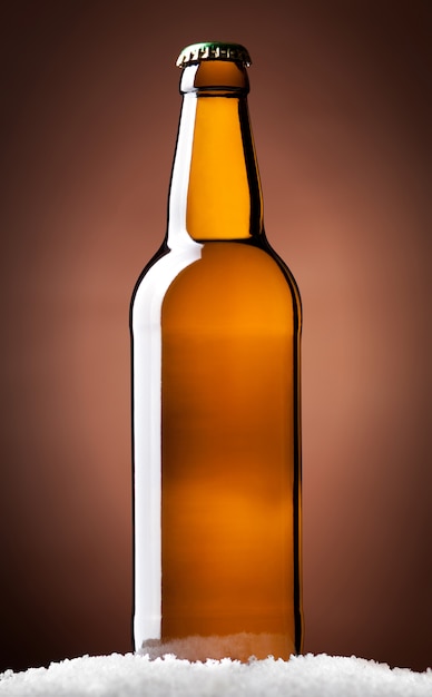 Photo bottle of beer on a brown