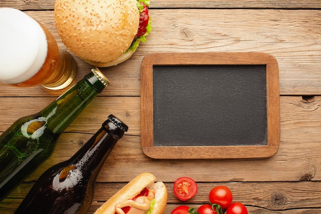 Bottle of beer and different snacks on rustic wooden table Top view