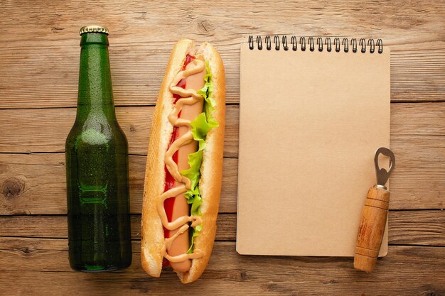 Bottle of beer and different snacks on rustic wooden table Top view