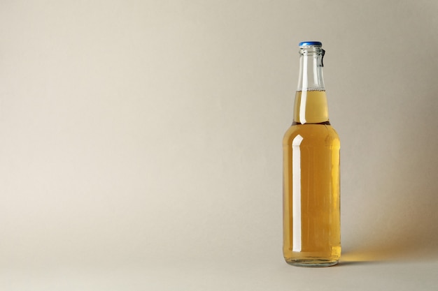 Bottle of beer on gray table, space for text