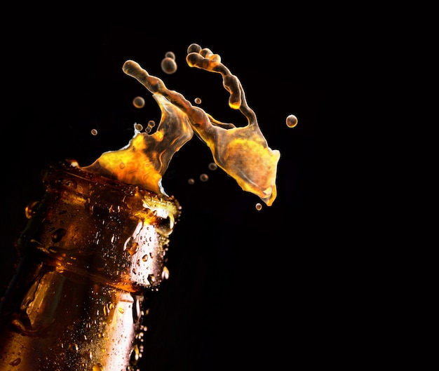 Bottle of beer with water drop falling