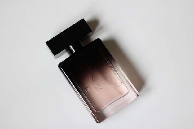 A bottle of black perfume in closeup on a white isolated background