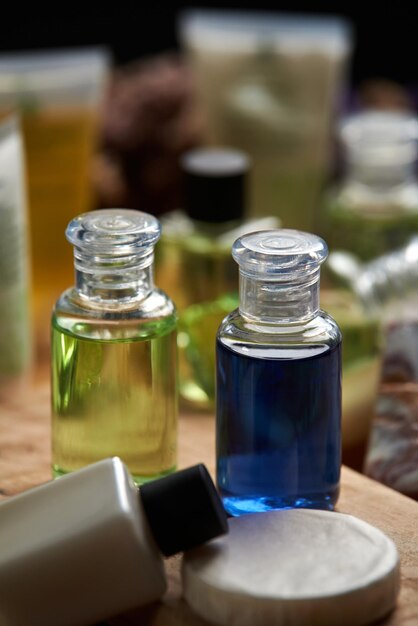 A bottle of blue liquid sits on a table with other bottles.