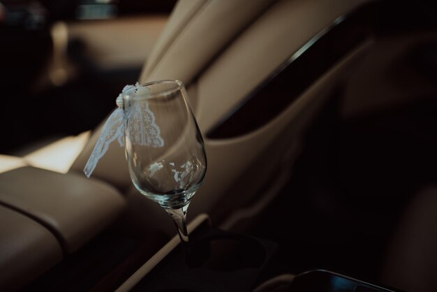 Bottle of champagne and glass in luxury car