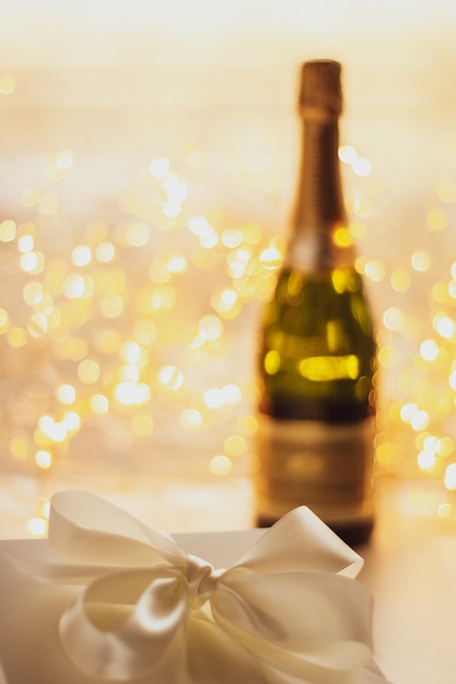 The bottle of champagne and holiday gift box