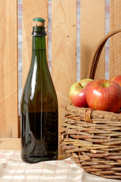 Bottle of cider with fresh apples