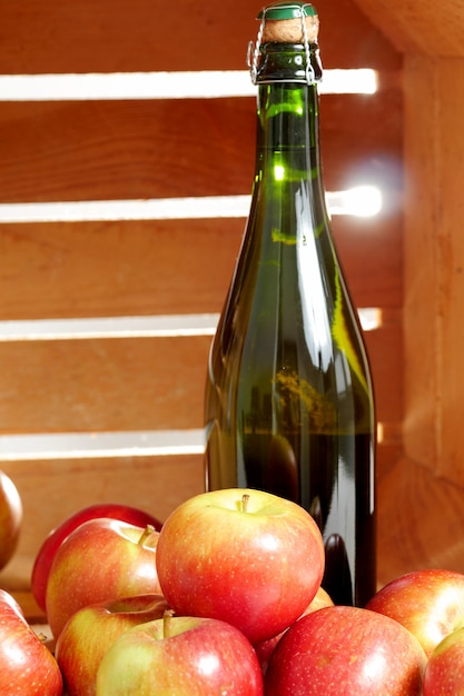 Bottle of cider with fresh apples
