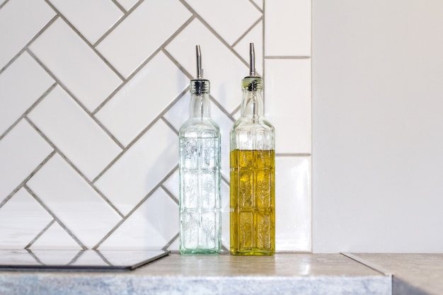 Bottle of cooking oil with ingredients on table in kitchen. The interior of the modern kitchen.