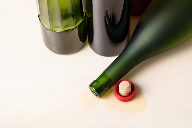 Bottle and cork in spilled cognac near bottles