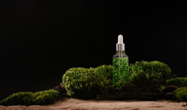 Bottle of cosmetic serum on natural background with moss
organic cosmetics