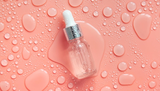 Bottle of cosmetics and drops of liquid moisturizing Hyaluronic acid Selective focus