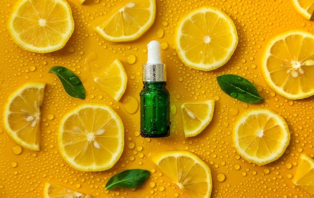 Bottle of cosmetics and drops of liquid moisturizing lemon Hyaluronic acid Selective focus