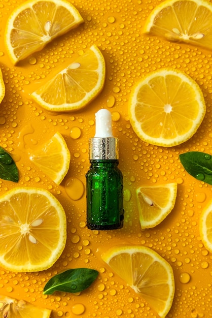 Bottle of cosmetics and drops of liquid moisturizing lemon Hyaluronic acid Selective focus