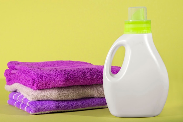 Bottle of detergent for colored and towels on yellow