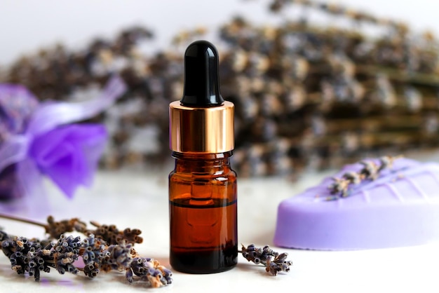 Bottle of essential oil with dropper and lavender soap closeup Set of lavender cosmetic