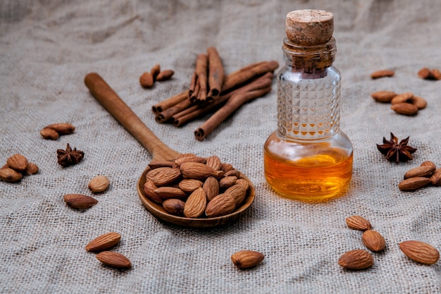 Bottle of extra virgin almonds oil with whole almonds.