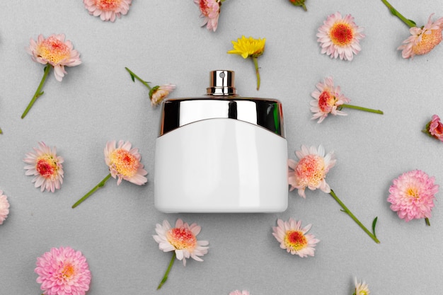 Bottle of fragrance surrounded by flower buds close up