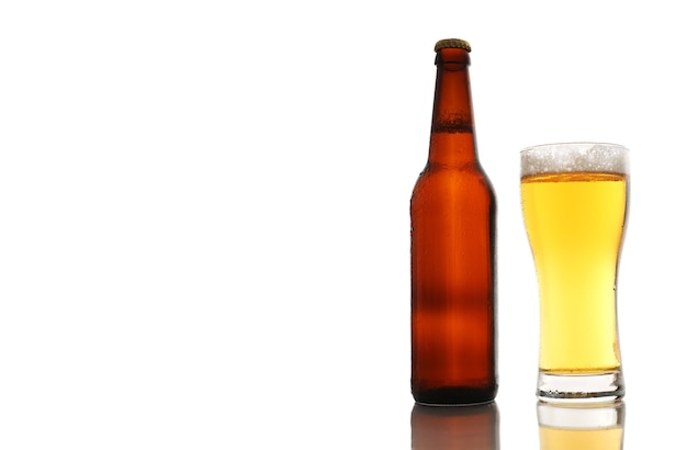 Bottle and a glass of beer with foam isolated on white background