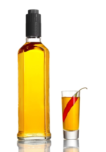 Bottle and glass of pepper vodka and red chili pepper isolated on white