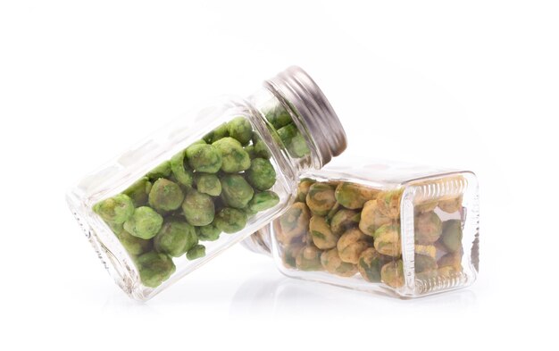 bottle of Green beans snacks and pistachio nut isolated on white background