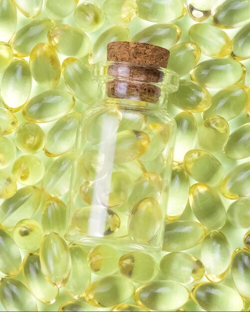 A bottle of green grapes with a cork cap on top of it.