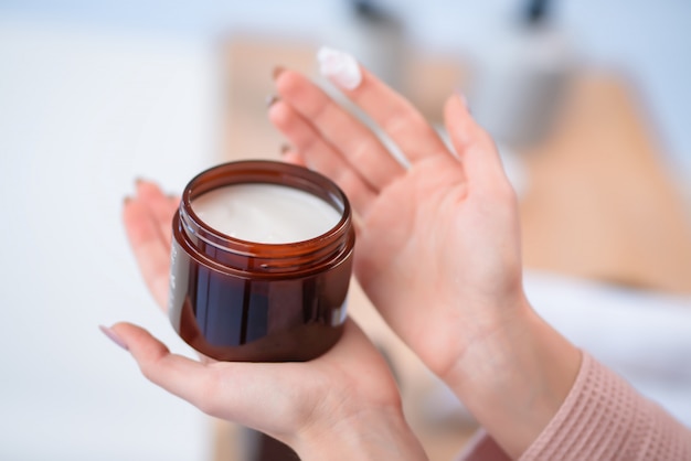 A  bottle in hand. Hair care product.