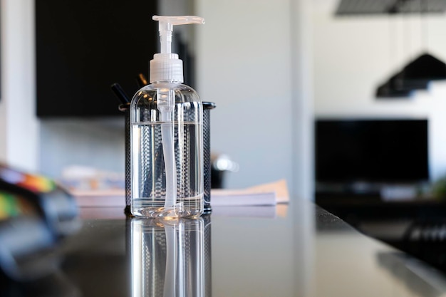 Bottle of Hand sanitizer on office reception counter to help clean hands