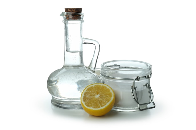 Bottle and jar of acid and lemon isolated on white isolated background