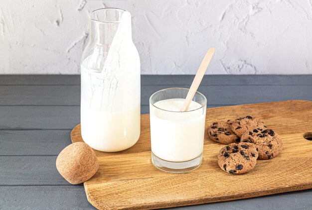 Bottle of kefir buttermilk or yogurt glass on kitchen table