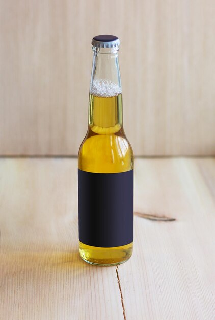 Bottle of the light beer on the wood background with dark mockup