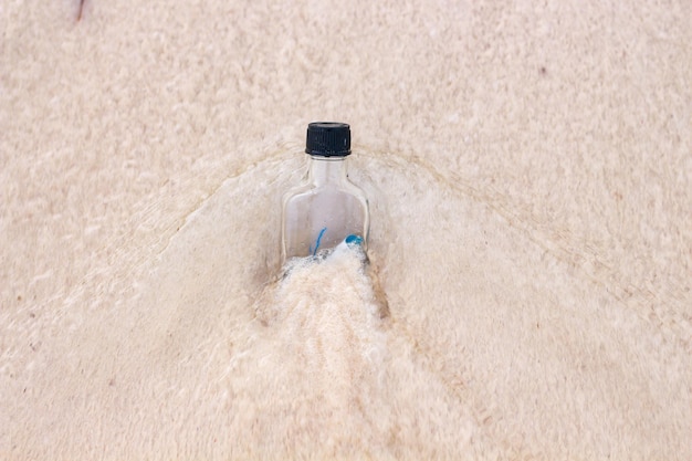 bottle message on the beach swept by the waves