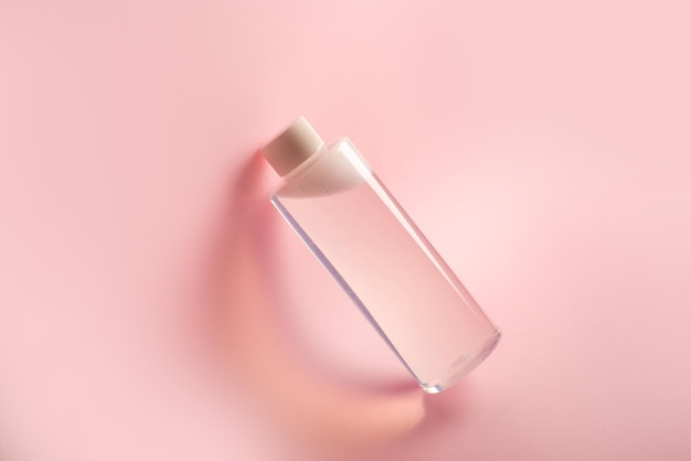 Bottle of micellar water on pink background