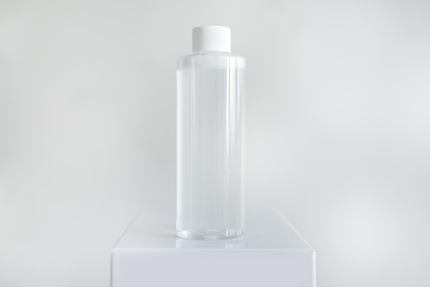 Bottle of micellar water tonic on a pedestal