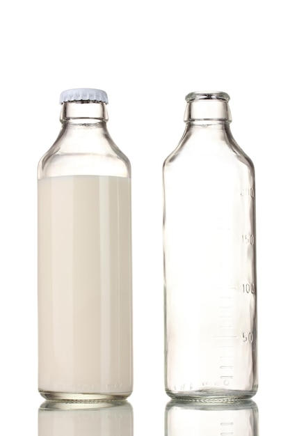 Photo bottle of milk and an empty bottle isolated on white