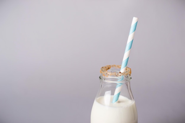 Bottle of milk is decorated with cookies crumbs