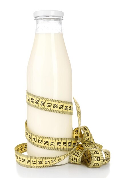 Bottle of milk with measuring tape isolated on white