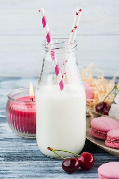 Bottle of milk with pink french macaroons