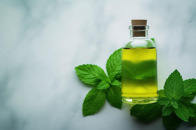 A bottle of mint oil next to a sprig of mint.