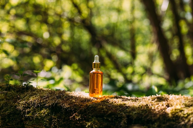 bottle mockup with dropper on nature background