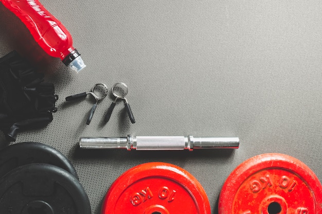 Bottle near parts of dumbbell