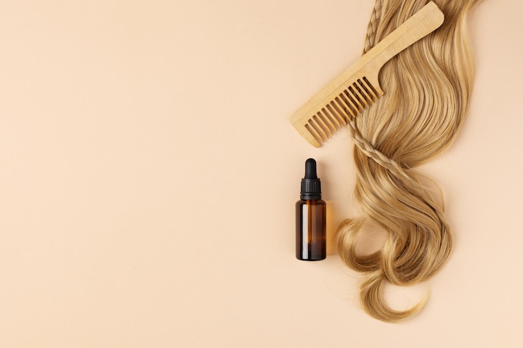 Photo 傷んだ髪の修復と回復のためのオイルのボトル ヘアカールとヘアオイルのトップビュー