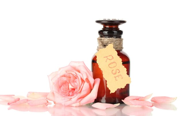 Photo bottle of oil and rose isolated on white