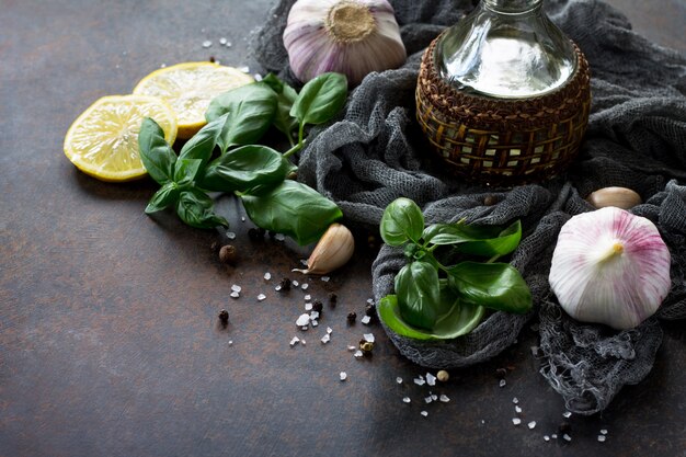 Bottle of olive oil and spices on stone table