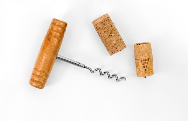 Photo bottle opener corkscrew with wooden handle and wine cork stopper isolated on white background with copy space