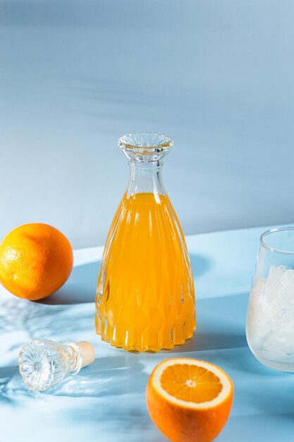 A bottle of orange juice sits next to a bottle of orange juice.